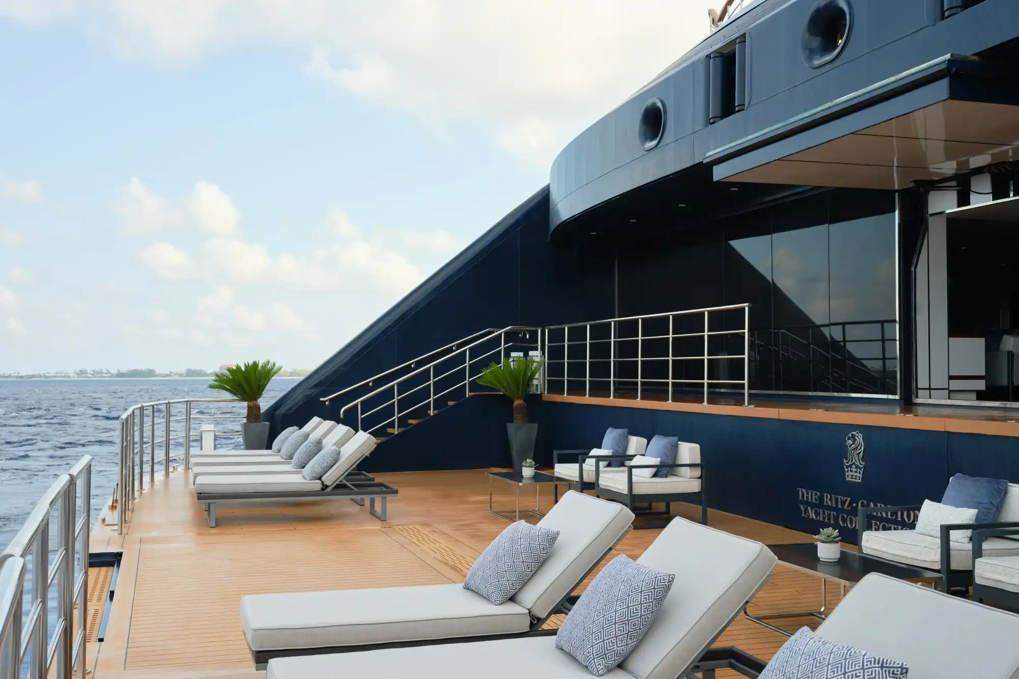 Gray lounge chairs on cruise deck overlooking the ocean
